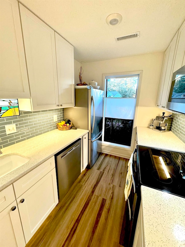 Kitchen featuring decorative backsplash, stainless