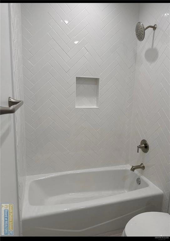 Bathroom featuring toilet and bathing tub / shower combination