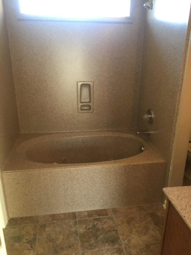 Bathroom featuring vanity and  shower combination