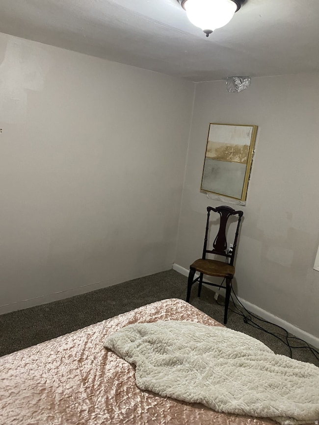 Bedroom featuring carpet and baseboards. APT 1