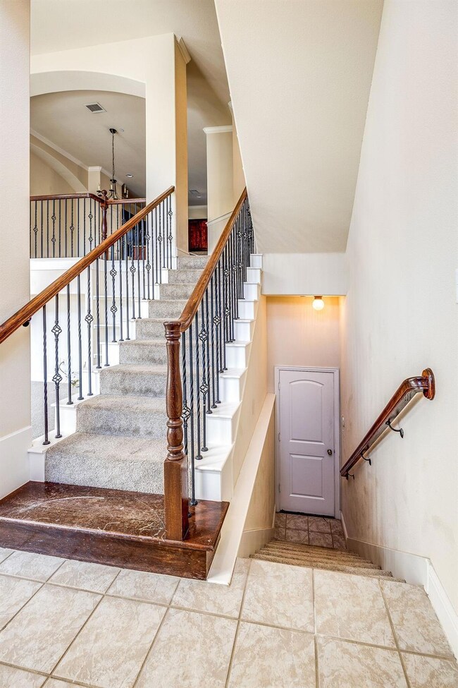 Stairs featuring tile floors