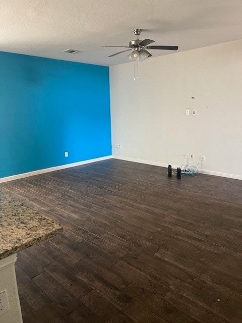 Unfurnished room with dark wood-type flooring, a textured ceiling, and ceiling fan