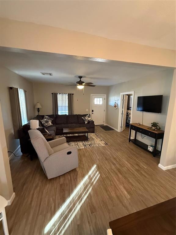 Living room with vinyl floors and ceiling fan