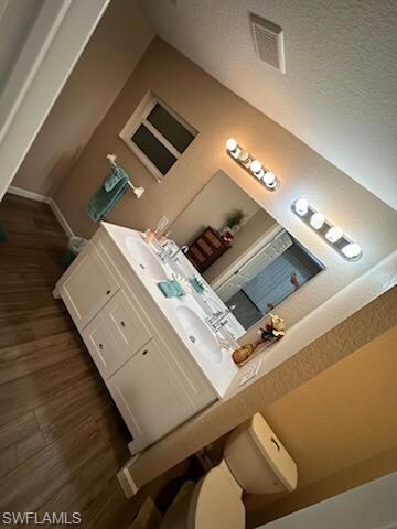 Bathroom with hardwood / wood-style floors, vanity