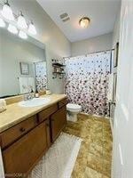 Full bath with vanity and curtained shower