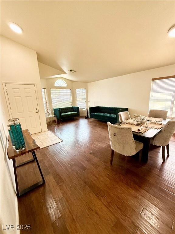 Dining space featuring visible vents, vaulted ceil