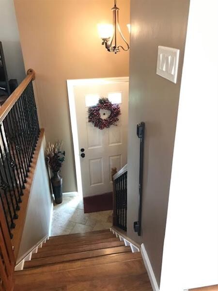 Welcoming Entry with wrought iron and oak railings