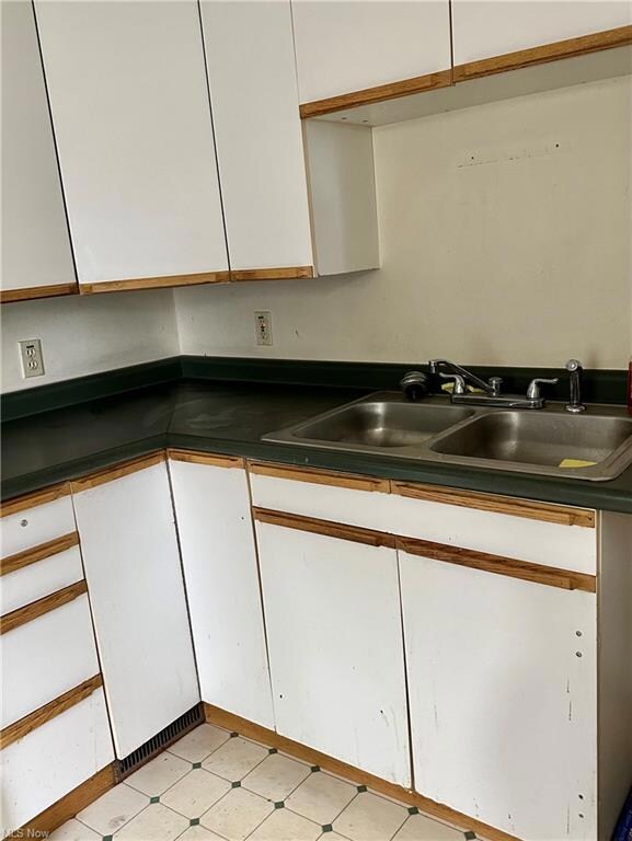 Kitchen featuring light tile floors, sink, counter