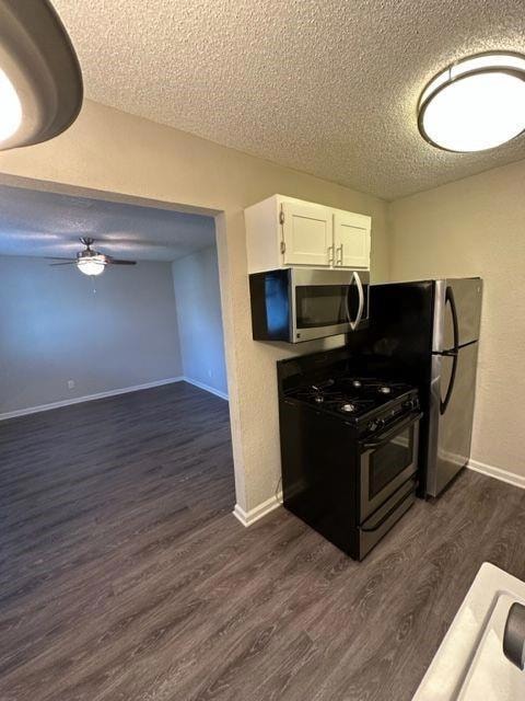 Kitchen with a textured ceiling, dark wood-style 