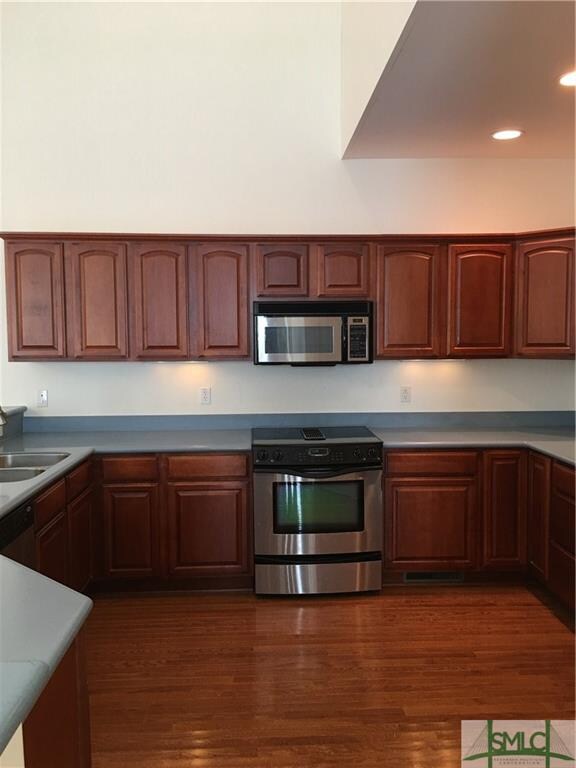 Kitchen with stainless steel appliance and hardwoo