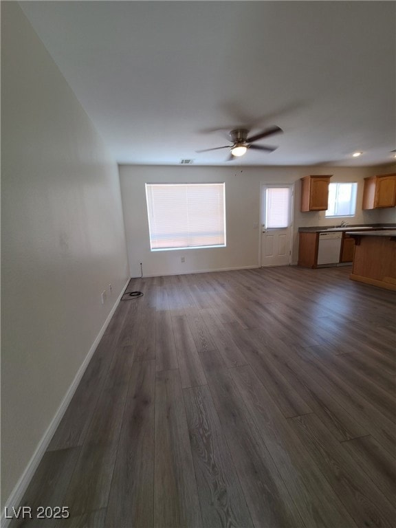 Unfurnished living room featuring dark wood-style