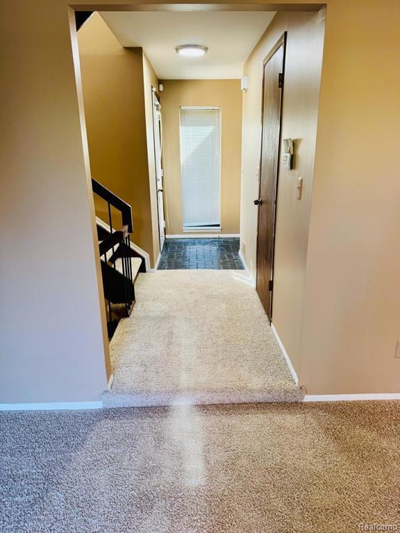 Corridor with carpet and baseboards