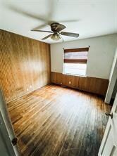 Empty room with hardwood / wood-style floors