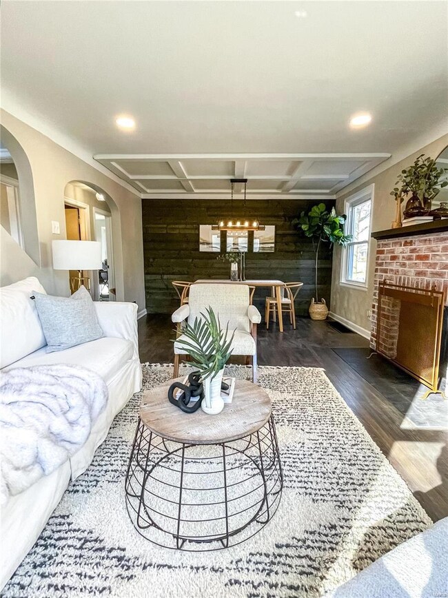 Custom coffered ceilings and wood wall shine as you enter the home
