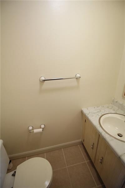 First floor powder room with ceramic tile floor.
