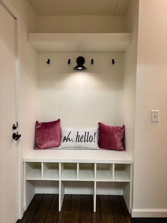 Entryway closet updated with bench,shoe and coat hooks.