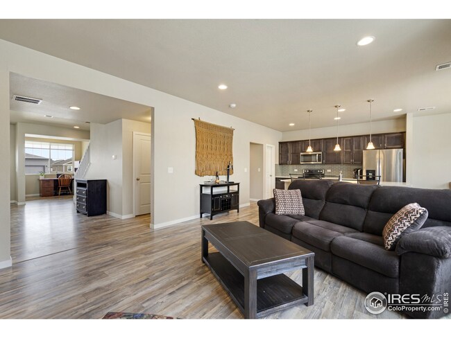 Living area facing entry way and kitchen. Large and open entryway