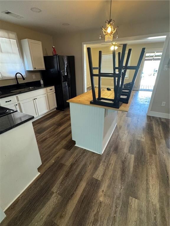 Kitchen featuring sink, dark wood-type flooring, w