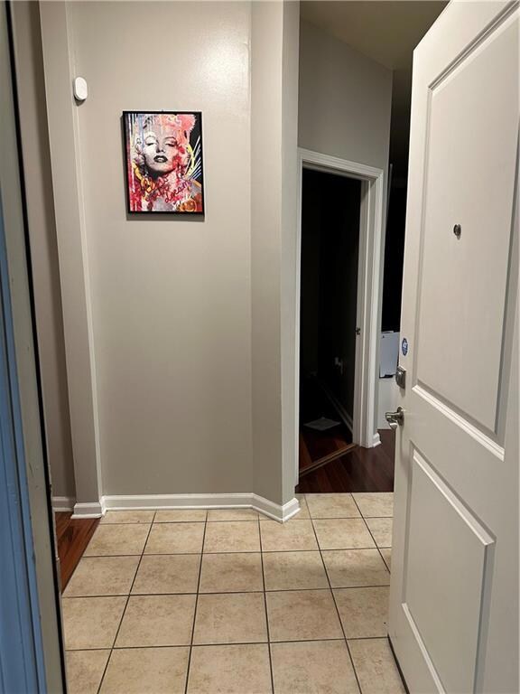 Hallway with light tile patterned flooring