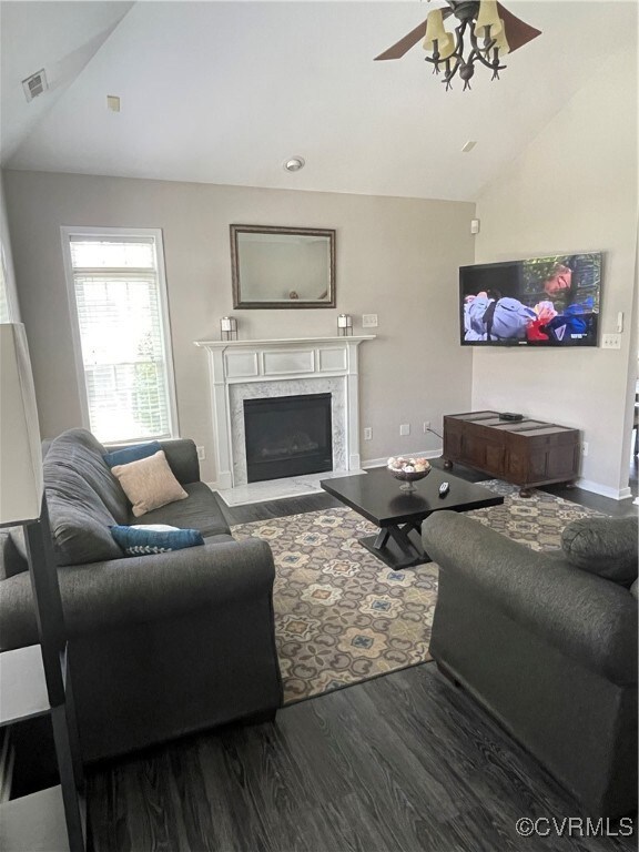 Living room featuring a premium fireplace, ceiling