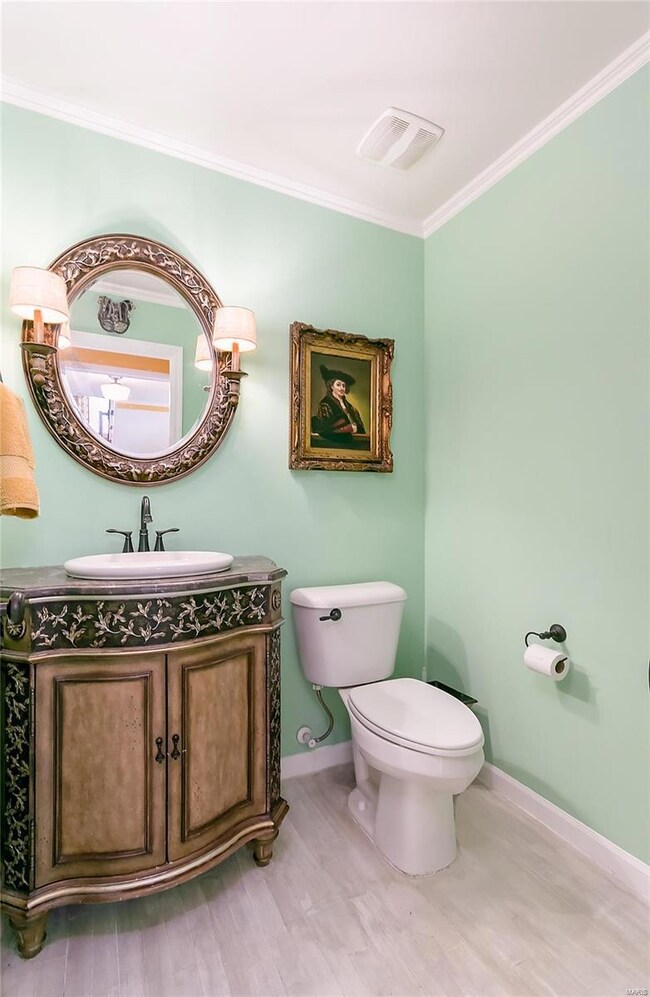 Remodeled Half Bath with Hardwood Flooring