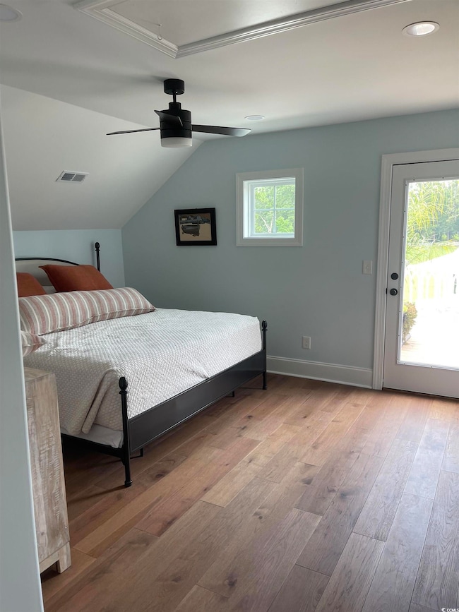 Bedroom with access to exterior, light wood finished floors, ceiling fan, and lofted ceiling