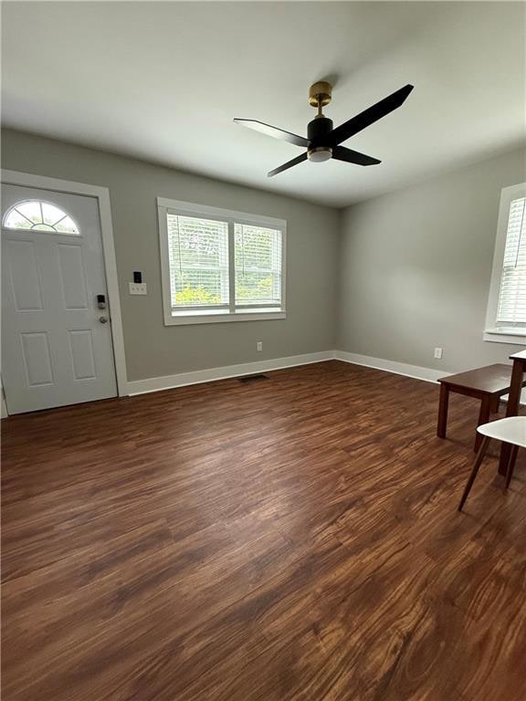 Entryway with dark wood finished floors and ceiling fan