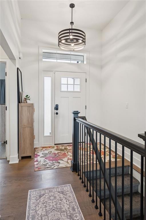 Entryway featuring engineered hardwood floors and stairs leading to finished basement.