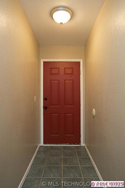 Covered front porch.  Foyer with ceramic tile.