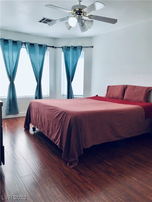 Primary  bedroom with beautiful wood flooring.