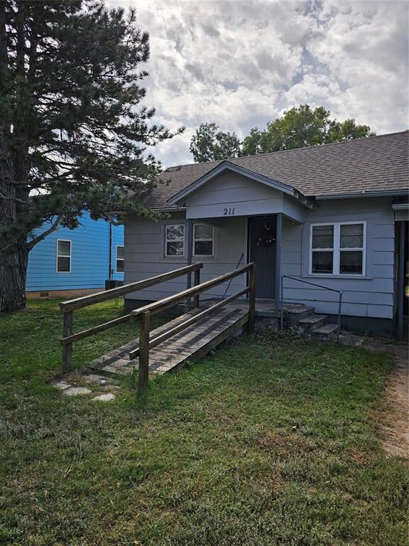 Bungalow-style home with a front yard