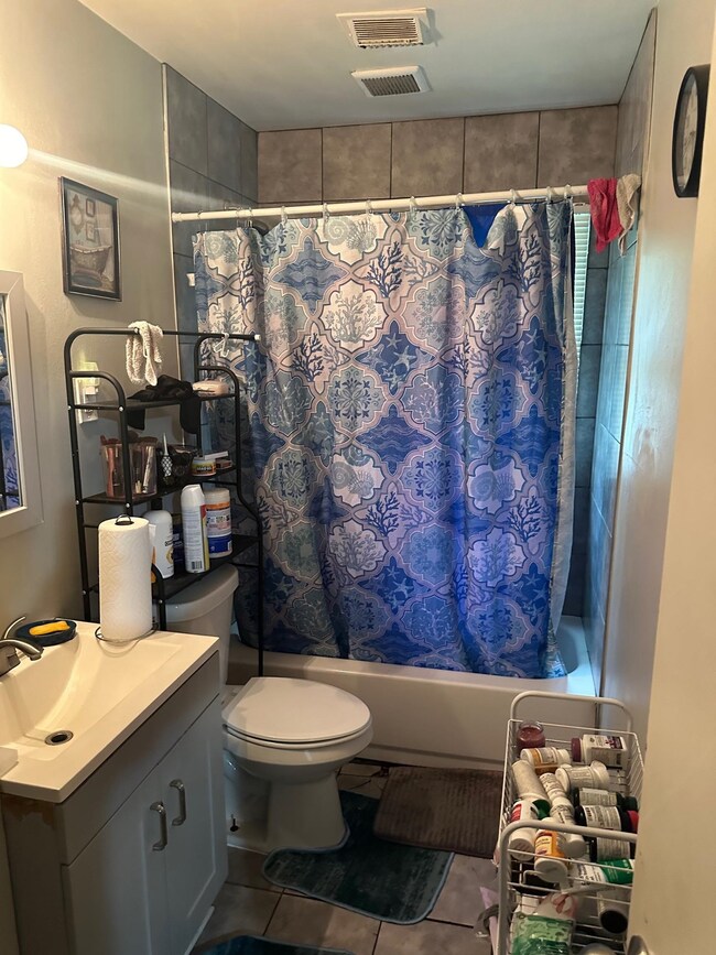 Full bathroom with vanity, shower / bathtub combin