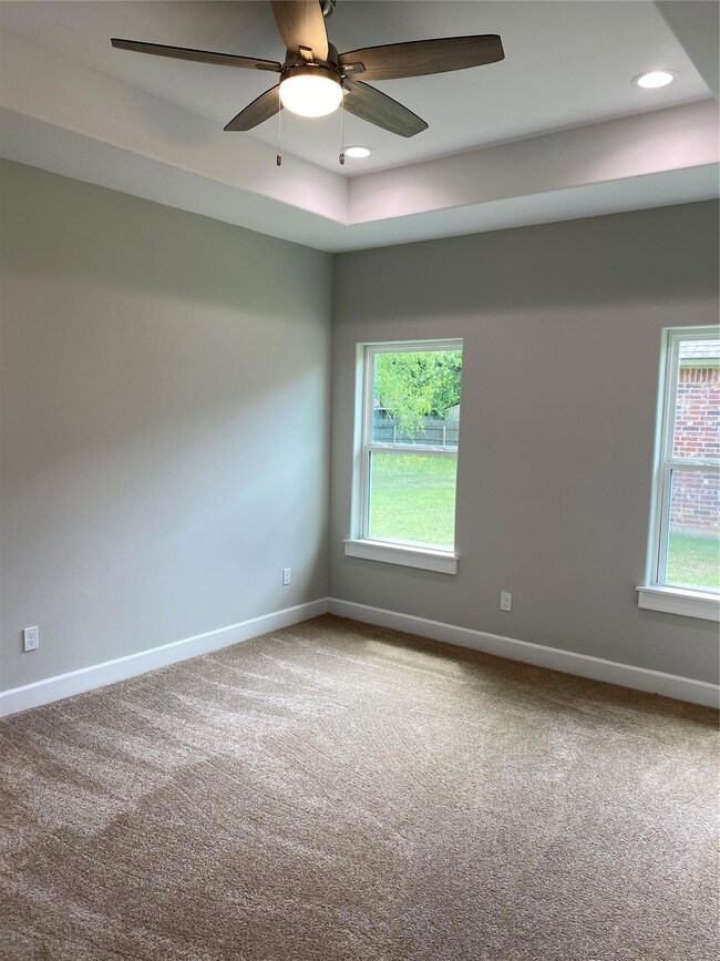 Spare room with light carpet and ceiling fan