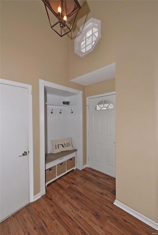 large entry foyer with gorgeous wood floors and darling cubby