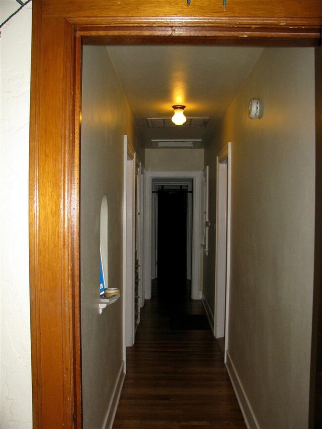 A built-in niche and built-in cabinets line the ha