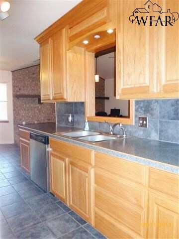 Right side of kitchen features custom framed openi