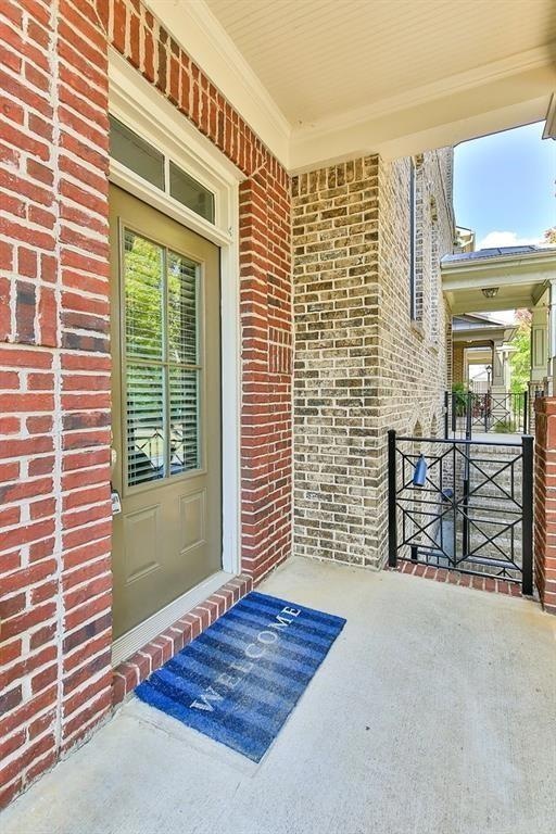 Doorway to property with brick siding