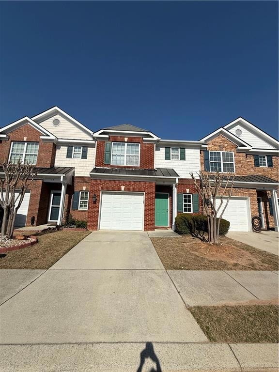 Townhome / multi-family property featuring brick s