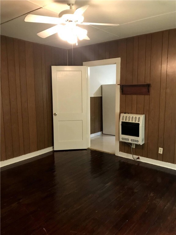 Unfurnished living room featuring heating unit, ce