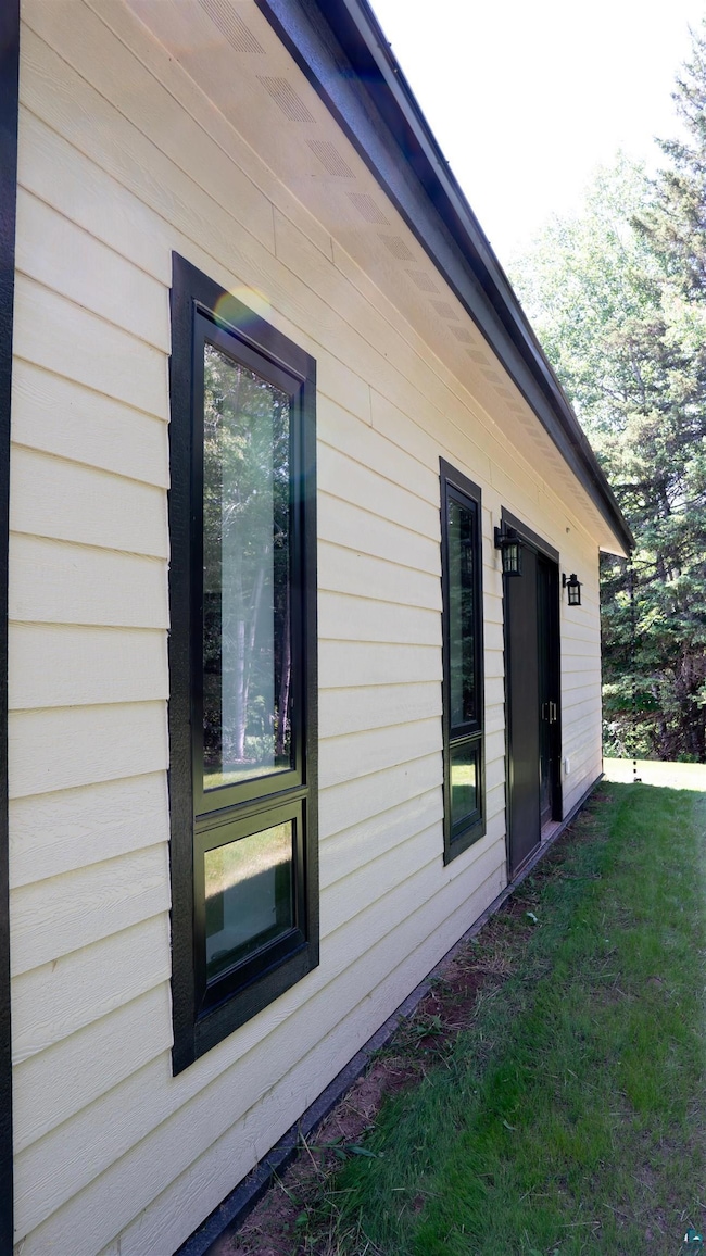 View of property exterior featuring a yard