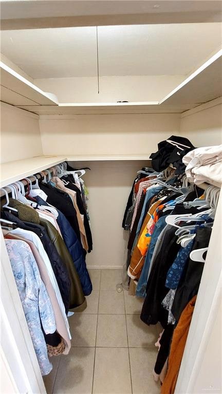 Spacious closet with light tile patterned flooring