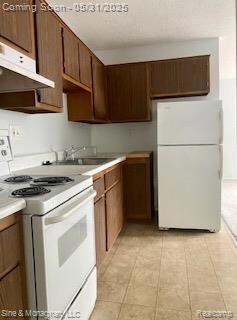 Newer stove and fridge, lots of storage and work space