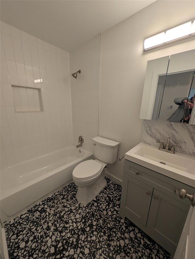 Bathroom with toilet, shower / bath combination, 