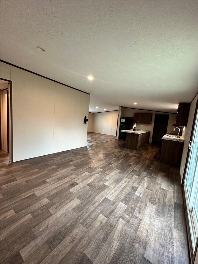 Unfurnished living room with a textured ceiling an