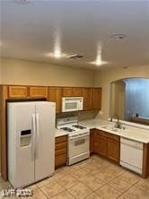 Kitchen with a sink, white appliances, brown cabin