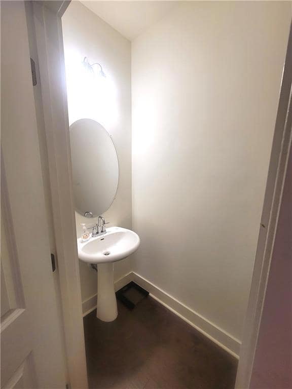 Bathroom with baseboards and wood finished floors
