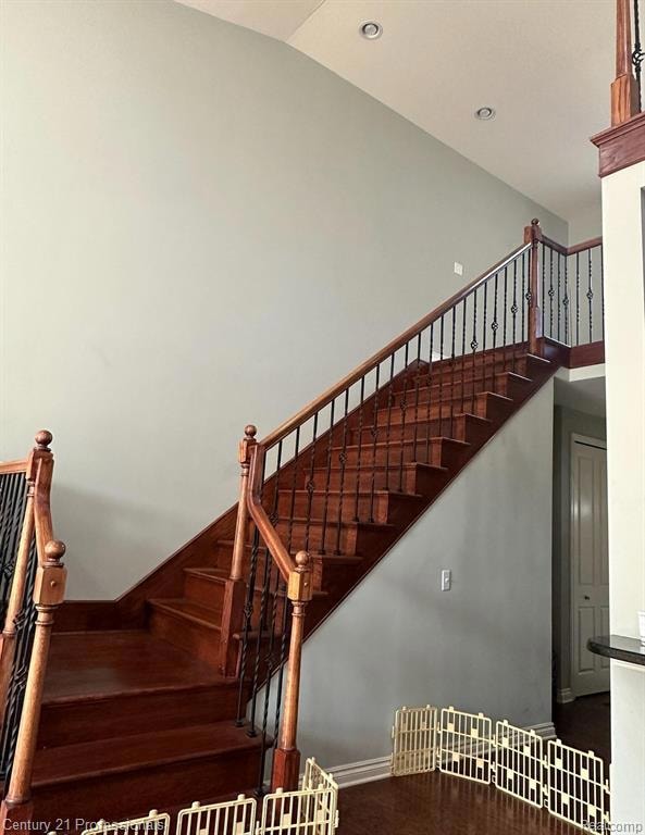 Stairs featuring recessed lighting and wood finished floors