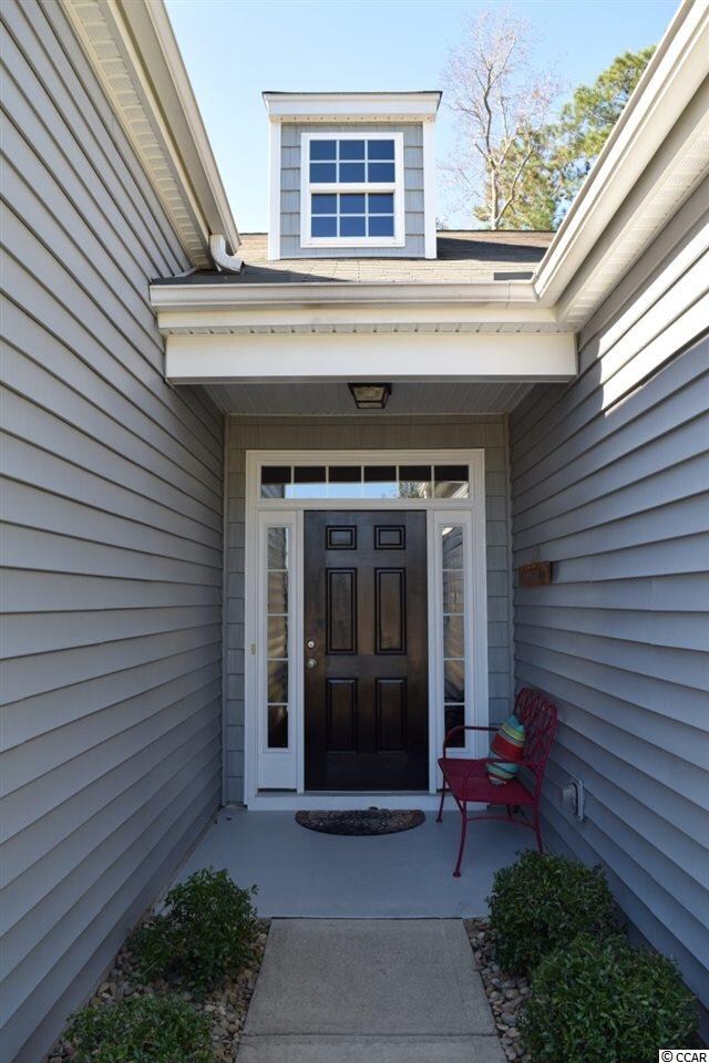 Front covered porch area with gutters, transom win