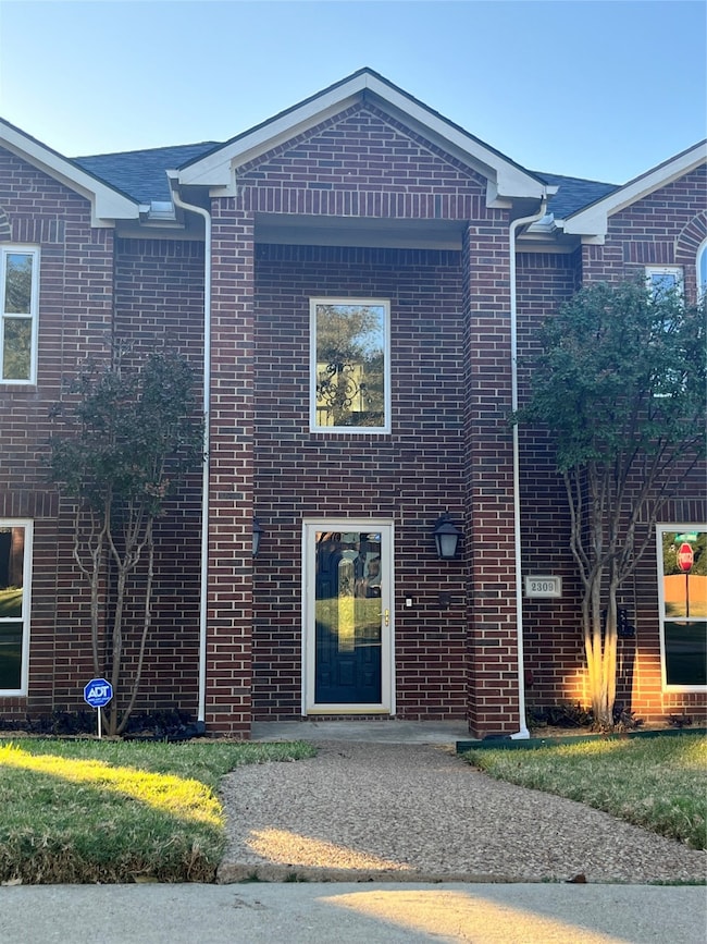 View of front of home featuring brick siding
