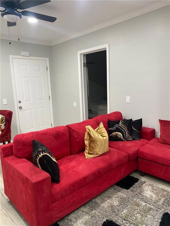 Living area with ceiling fan, ornamental molding, and wood finished floors
